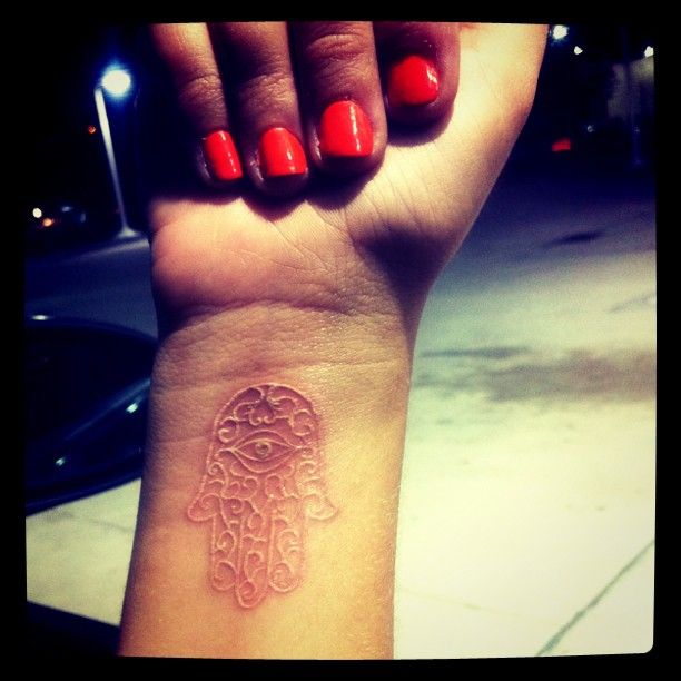 White Ink Hamsa Tattoo On Girl Wrist