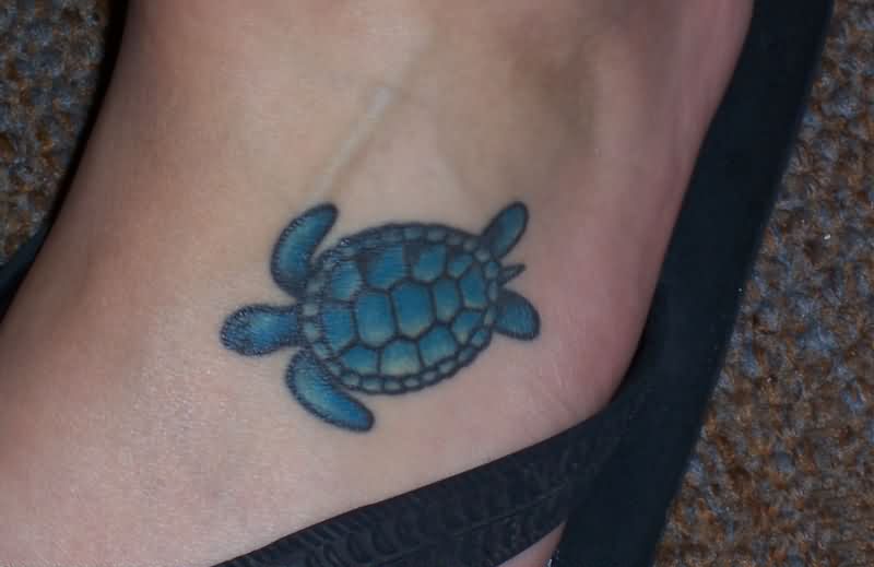 Blue Ink Baby Turtle Tattoo On Left Foot
