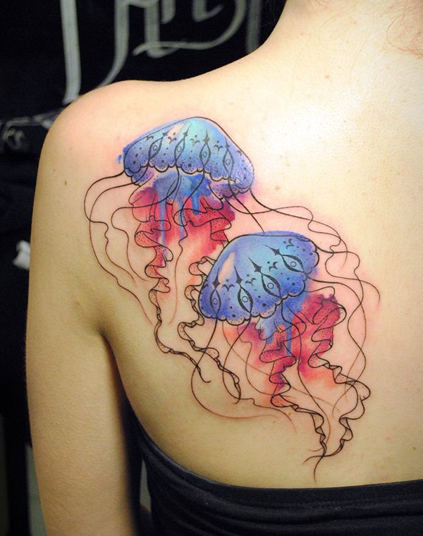 Colorful Jellyfish Tattoo On Girl Left Back Shoulder