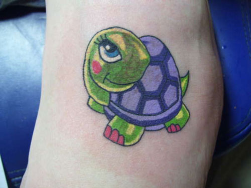 Green And Purple Ink Baby Turtle Tattoo On Left Foot