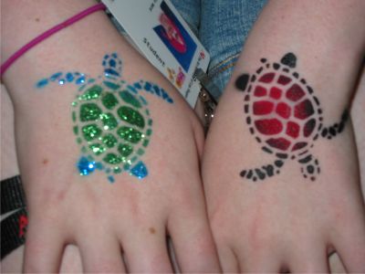 Green And Red Turtle Tattoos On Hands