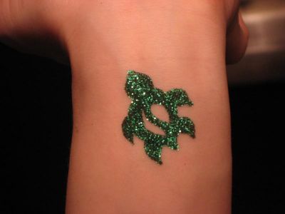 Green Ink Glitter Tattoo On Left Wrist