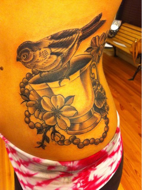 Grey Ink Bird And Teacup Tattoo On Side Rib