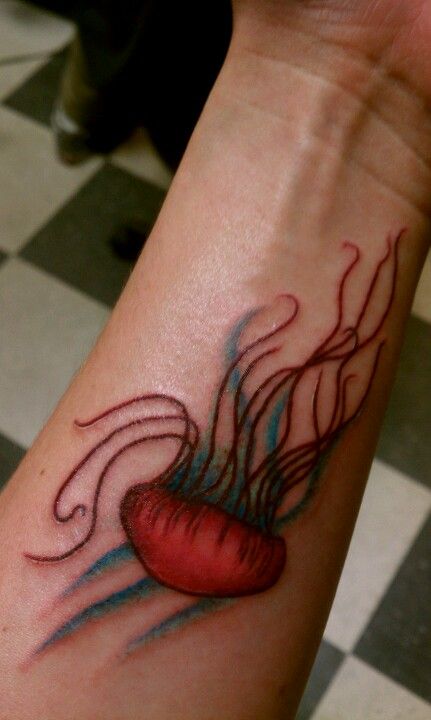 Red Ink Jellyfish Tattoo On Left Forearm