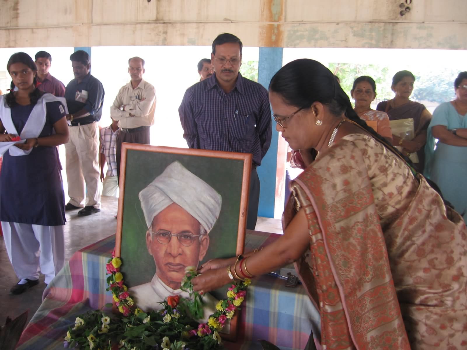 A School Teacher Present Flowers To The Dr. S. Radhakrishnan Photo On Teachers Day Celebration