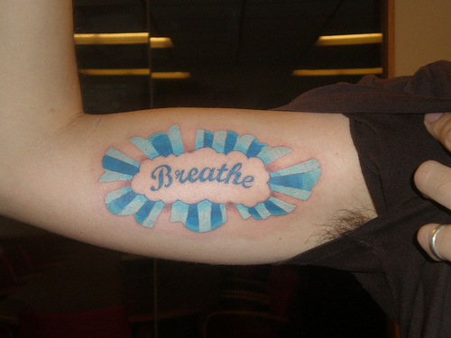 Attractive Breathe Lettering Tattoo On Bicep