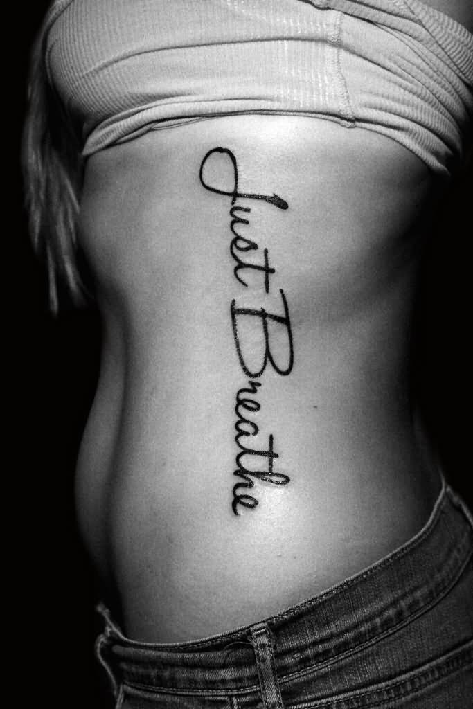Attractive Just Breathe Lettering Tattoo On Girl Side Rib By Deanna Wardin