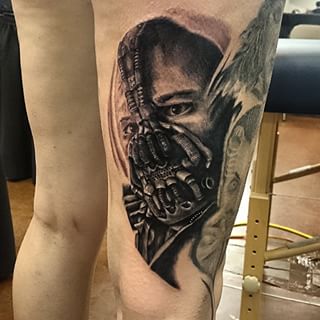 Black And Grey 3D Bane Face Tattoo On Right Back Thigh