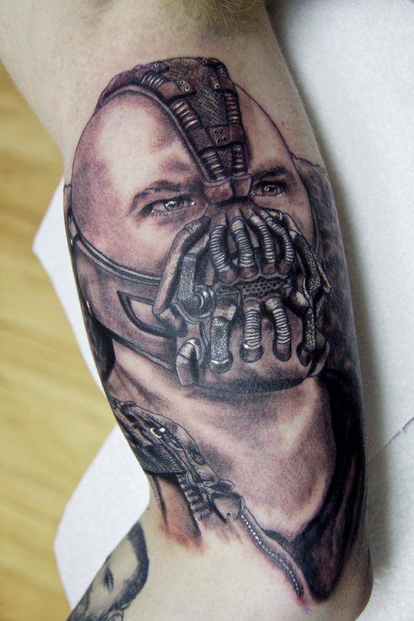 Black And Grey Bane Face Tattoo Design For Bicep By Craig
