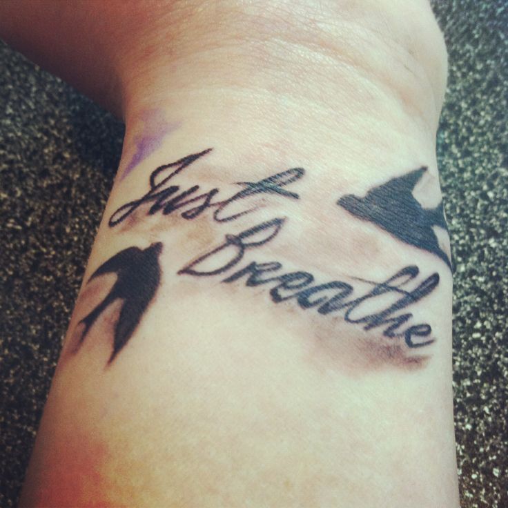 Black Ink Flying Birds With Just Breathe Lettering Tattoo Design For Wrist