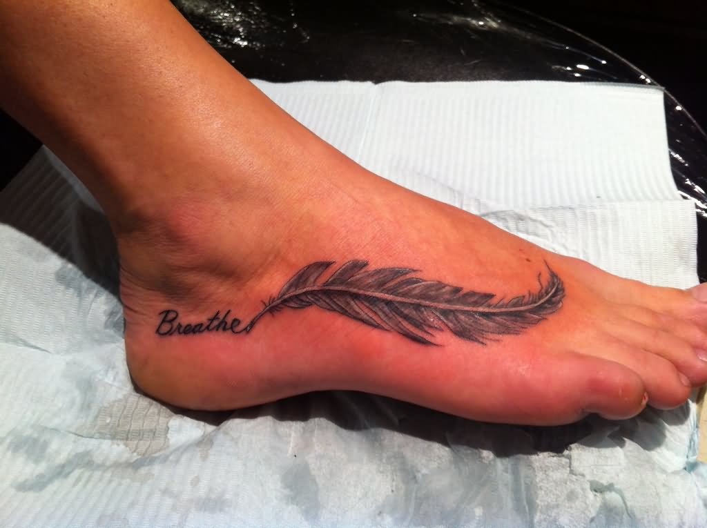 Breathe Lettering With Feather Tattoo On Right Foot