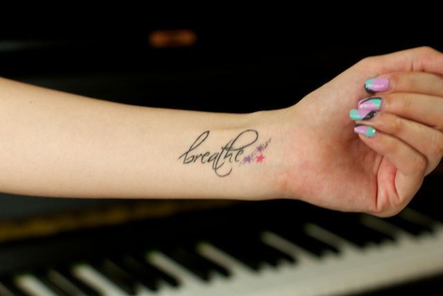 Breathe Lettering With Stars Tattoo On Girl Left Wrist
