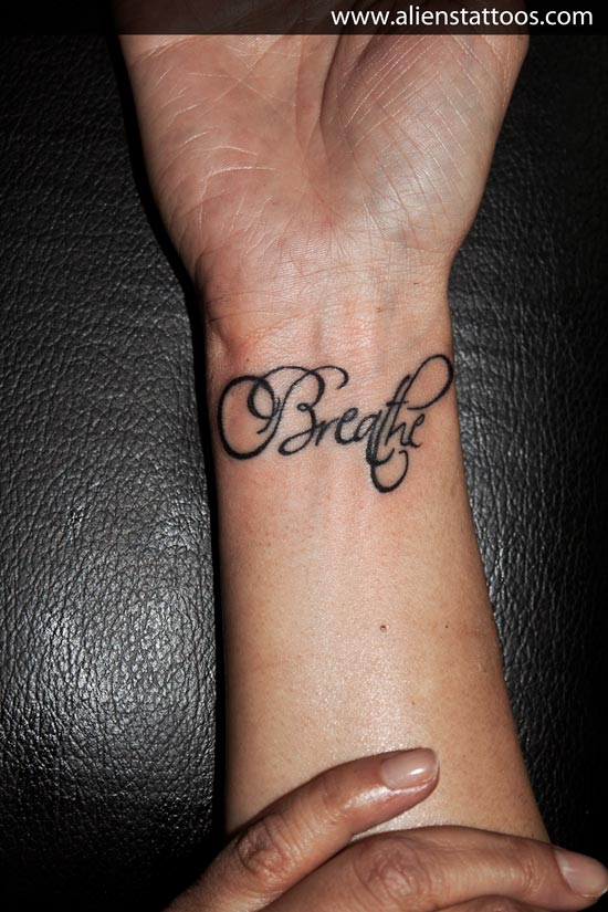 Classic Breathe Lettering Tattoo On Right Wrist