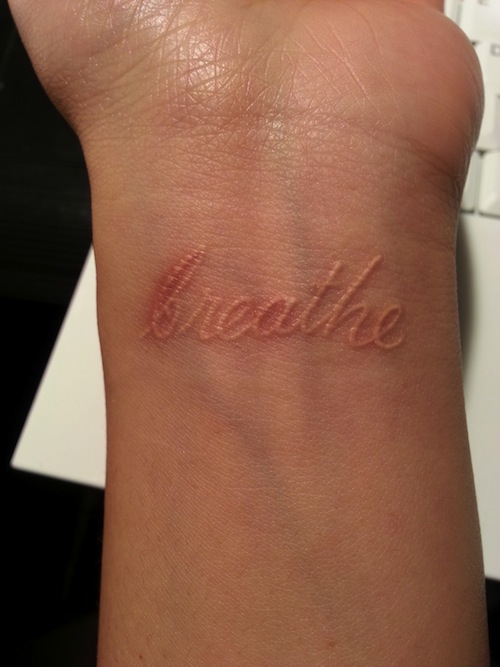 Classic White Ink Breathe Lettering Tattoo On Wrist