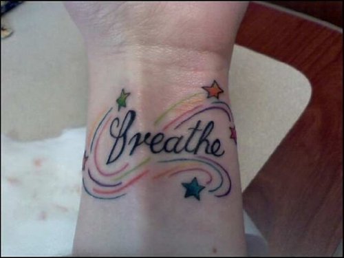Colorful Stars With Breathe Lettering Tattoo On Wrist
