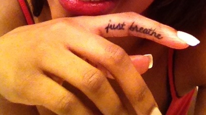 Just Breathe Lettering Tattoo On Girl Finger