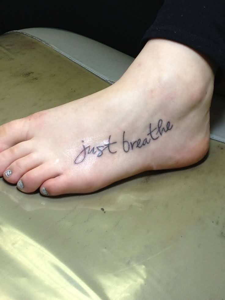 Just Breathe Lettering Tattoo On Girl Left Foot