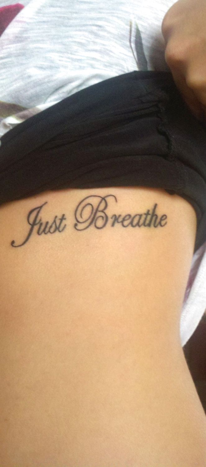 Just Breathe Lettering Tattoo On Girl Side Rib