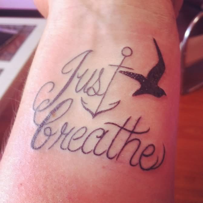 Just Breathe Lettering With Anchor And Flying Bird Tattoo Design For Wrist