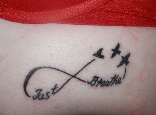 Just Breathe Lettering With Infinity And Flying Birds Tattoo Design