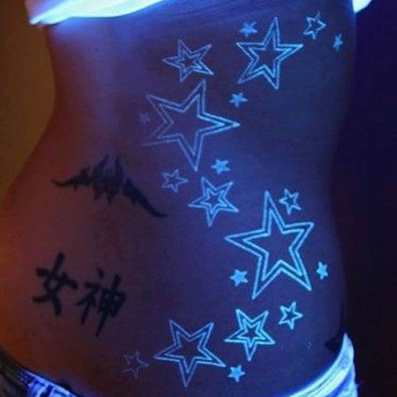 Nice Blacklight Stars Tattoo On Body