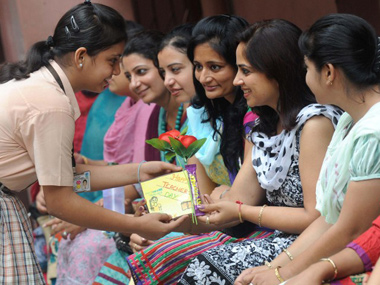 School Girl Offering Wishes To A Teacher During Teachers Day Celebration