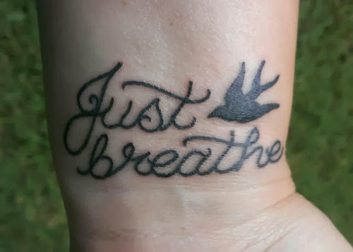 Silhouette Flying Bird With Just Breathe Lettering Tattoo Design For Wrist