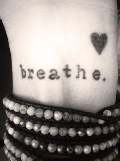 Silhouette Heart With Breathe Lettering Tattoo On Wrist