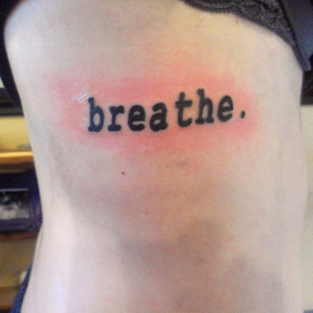 Simple Breathe Lettering Tattoo On Side Rib
