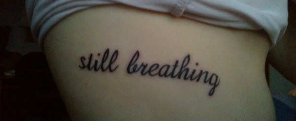 Still Breathing Lettering Tattoo Design For Side Rib