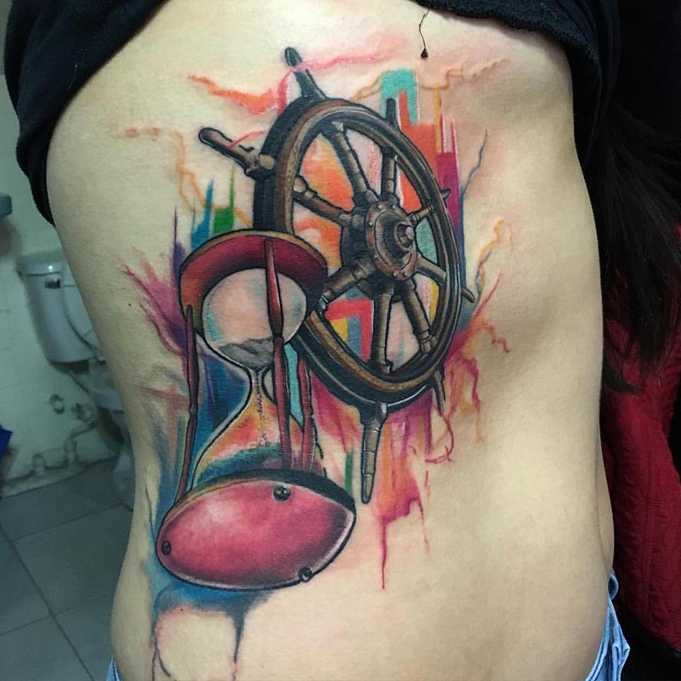Watercolor Hourglass And Sailor Wheel Tattoo On Side Rib