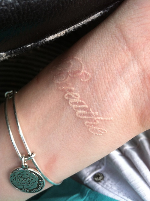 White Ink Breathe Lettering Tattoo Design For Girl Wrist