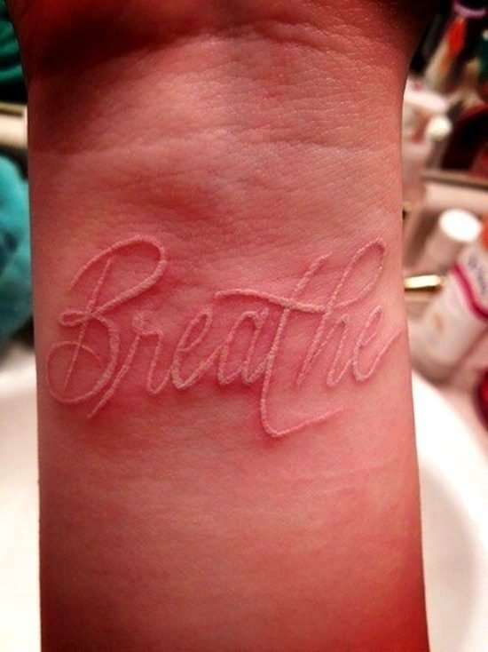 White Ink Breathe Lettering Tattoo Design For Wrist