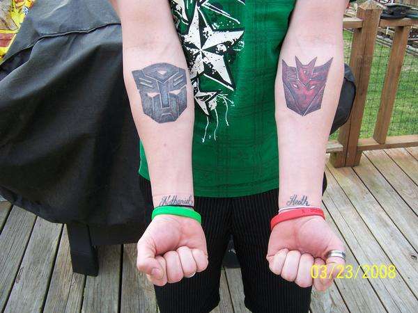Awesome Two Transformer Logo Tattoo On Both Forearm