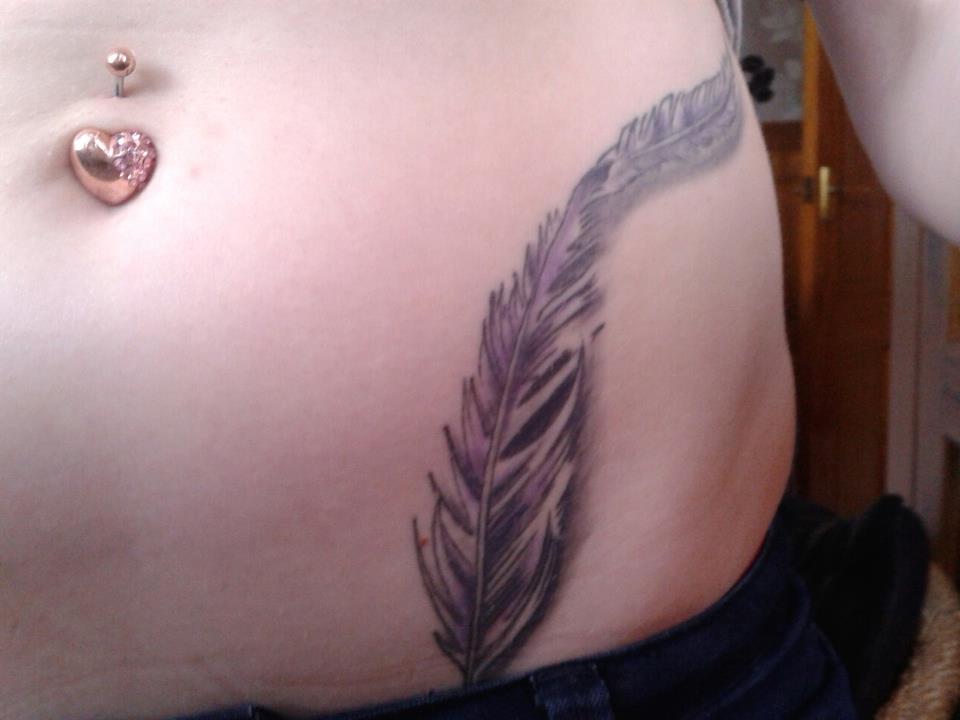 Black And Grey Feather Tattoo On Girl Left Hip