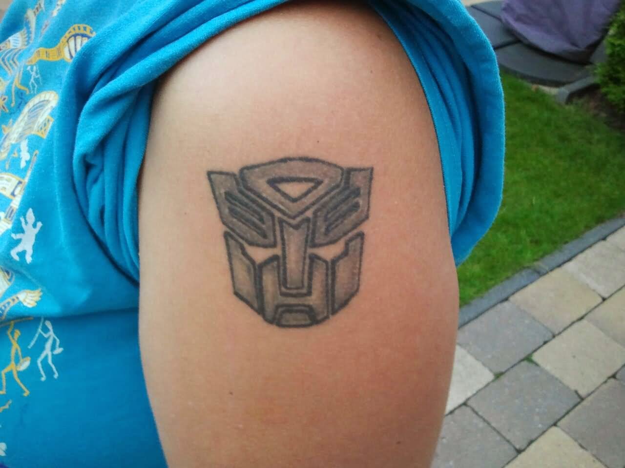 Black And Grey Transformer Logo Tattoo Design For Shoulder By Selma Timmermans