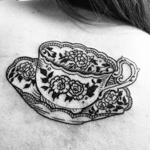 Black And White Teacup Tattoo On Girl Collarbone