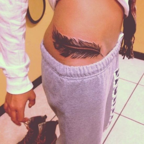 Black Ink Feather Tattoo On Girl Right Hip