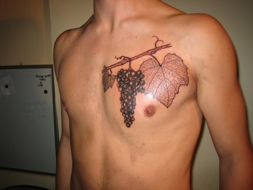 Black Ink Grapes Tattoo On Man Chest