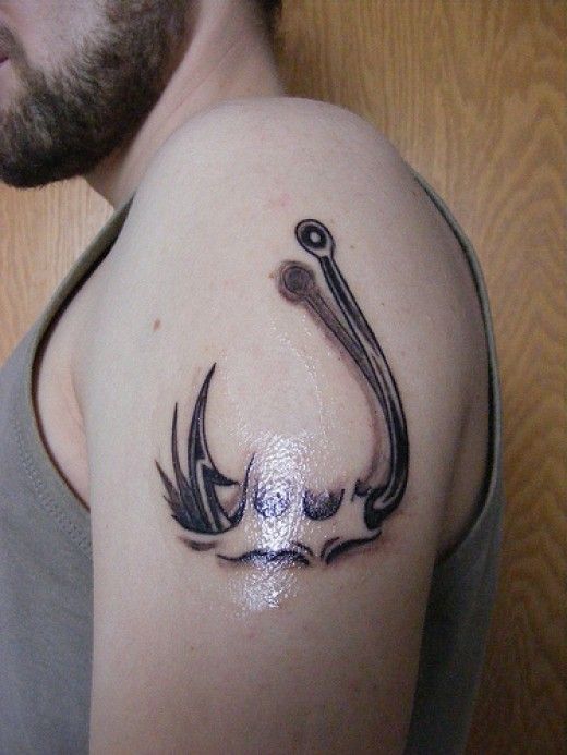 Black Ink Hook Tattoo On Man Left Shoulder