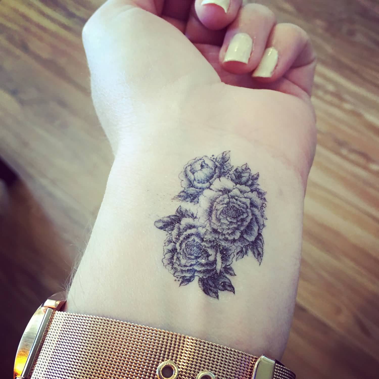 Black Ink Peony Flowers Tattoo On Girl Left Wrist