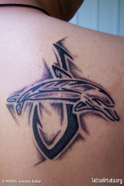 Black Ink Tribal Dolphin With Hook Tattoo On Man Right Back Shoulder