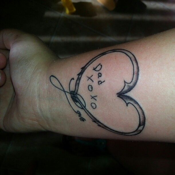 Black Ink Two Hook Heart Tattoo On Wrist