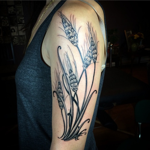 Black Ink Wheat Tattoo On Girl Left Half Sleeve