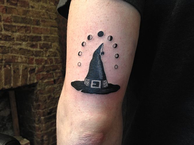 Black Ink Witch Hat Tattoo On Bicep