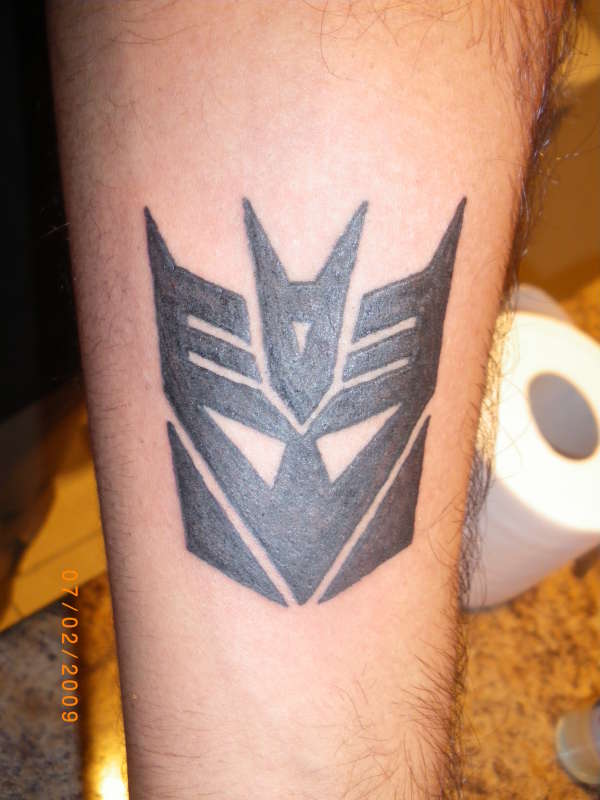 Black Transformer Logo Tattoo Design For Forearm