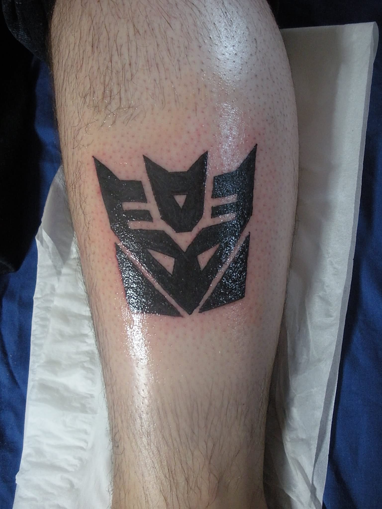 Black Transformer Symbol Tattoo Design For Leg By Vinyard83