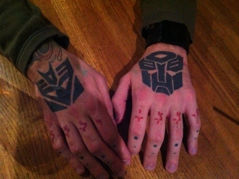 Black Two Transformer Logo Tattoo On Both Hand