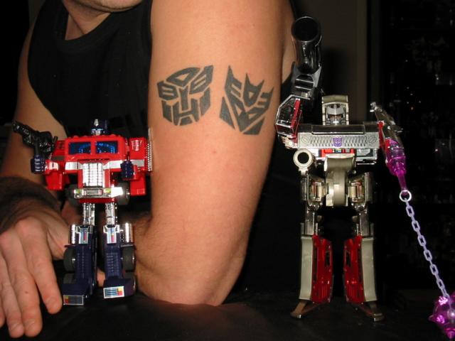 Black Two Transformer Logo Tattoo On Left Half Sleeve