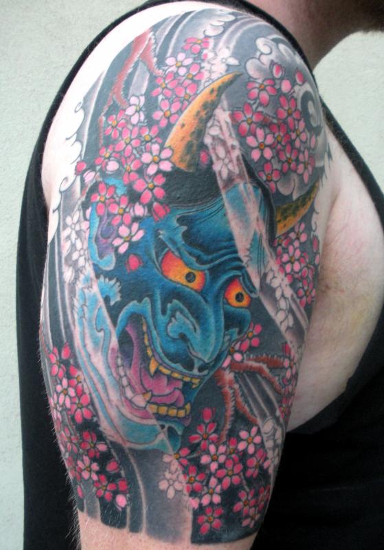 Blue Ink Hannya Mask Tattoo On Right Half Sleeve